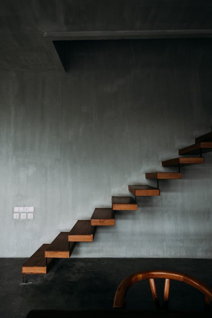 zipwp-image-4577688 Interior design of wooden stairway in apartment with modern minimalist style with gray walls
